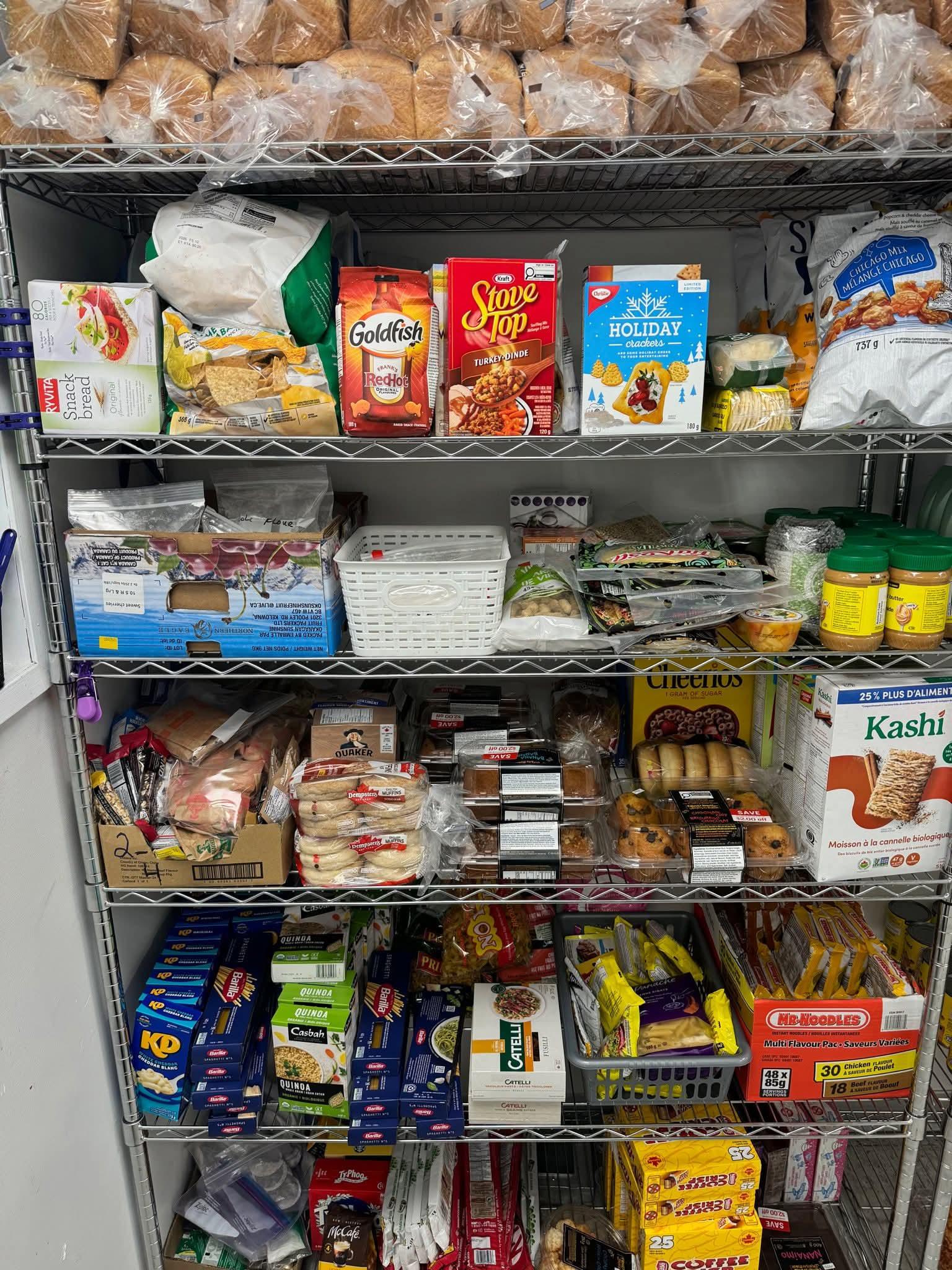 Large pantry shelves stocked with food donations